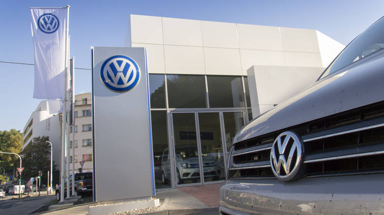A Volkswagen car in front of a Volkswagen service center