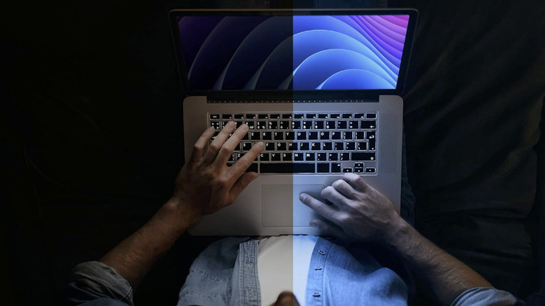 A man on a laptop with one half dimmed by the Kensington MagPro Magnetic.