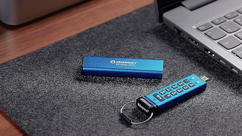 A Kingston IronKey Keypad 200 next to a laptop.