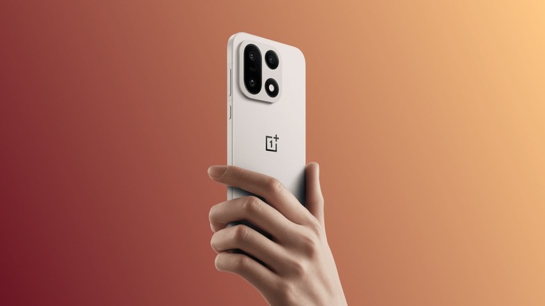 A OnePlus 15 phone in a hand of a woman
