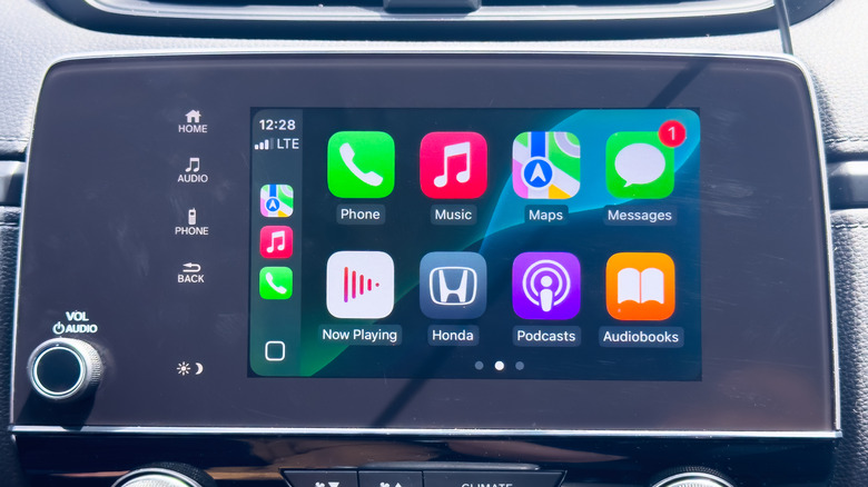A close-up view of an infotainment system hooked above climate controls