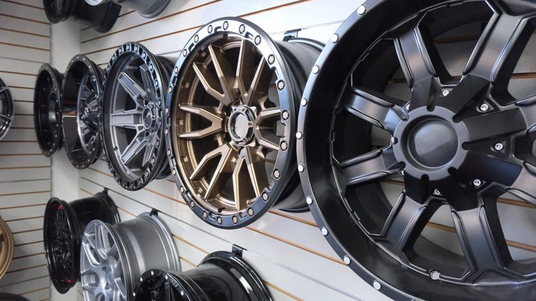 A selection of car rims hanging on a garage wall