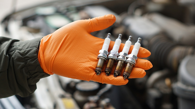 Mechanic holding spark plug