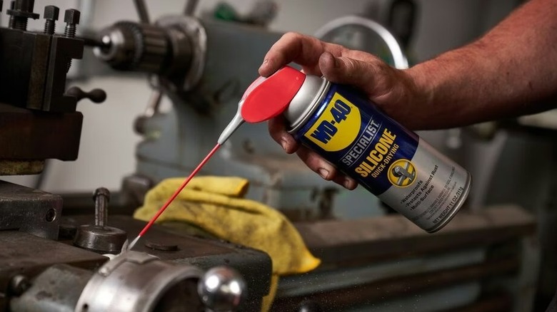 A person using WD-40 Specialist Silicone on a machine