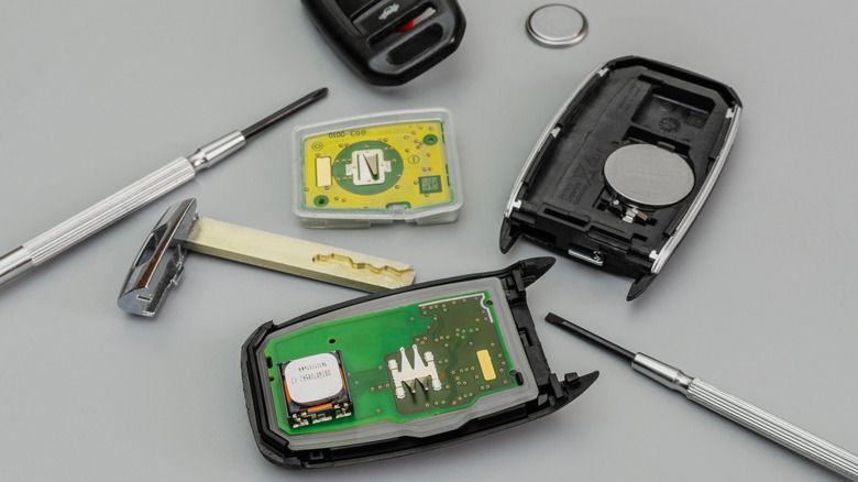 A broken or damaged key fob with the internals laid out on a table