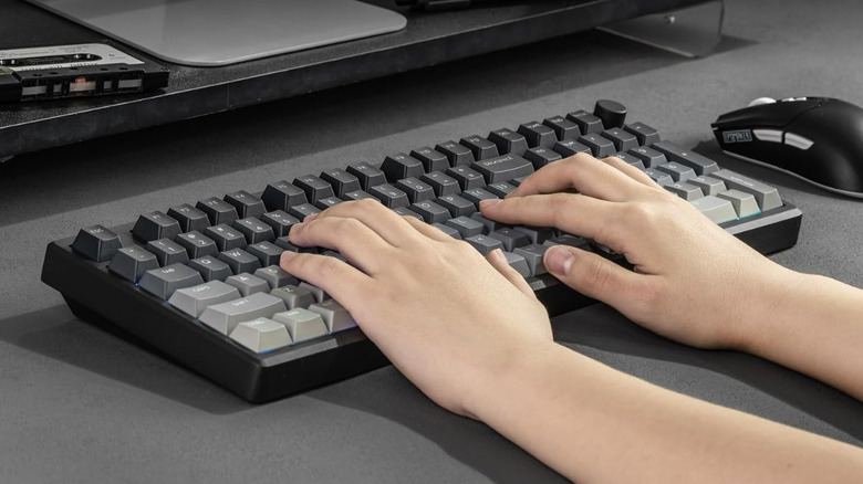 Hands using an Epomaker Galaxy 100 Lite in black.