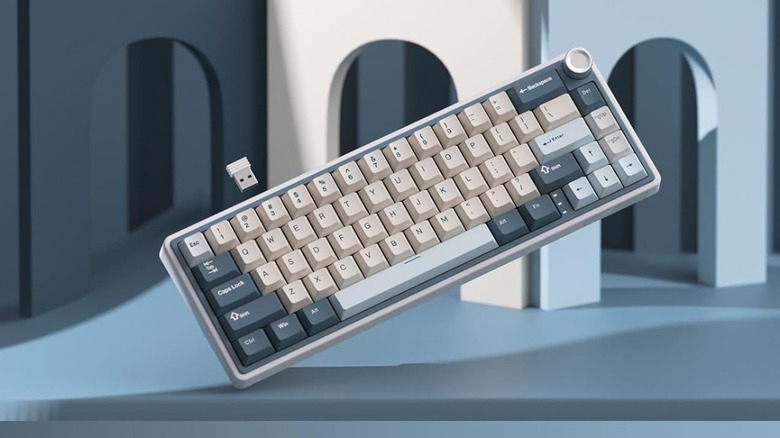 A blue and white Royal Kludge RK65 in the air.