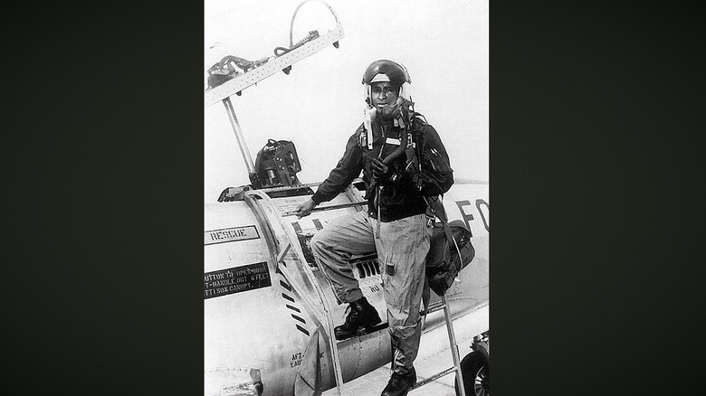 lawrence standing beside plane