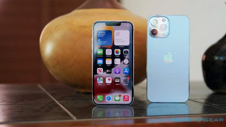 A blue iPhone 13 Pro Max on a tile table