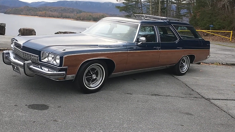 A 1973 Buick Estate Wagon finished here in two-tone bronze and blue paint, standing next to a body of water.