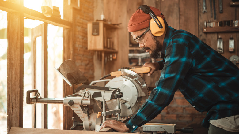 woodworker wearing ear protection while sawing