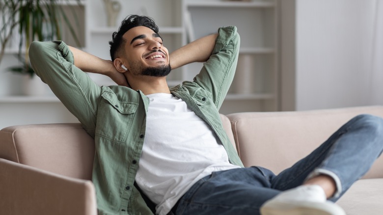 A person relaxing and listening to their AirPods