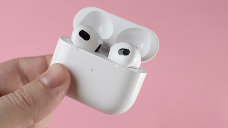 Holding a pair of AirPods