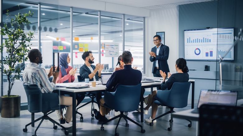 Colleagues applauding a business presentation