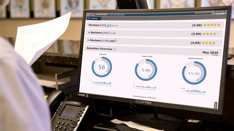 Worker inspecting computer screen with information about reviews.