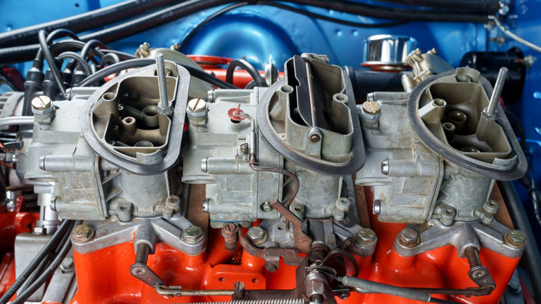Plymouth Barracuda showing the engine and triple carburetors