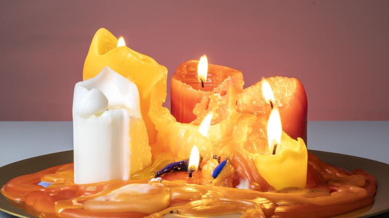 a few candles burning, most are entirely melted