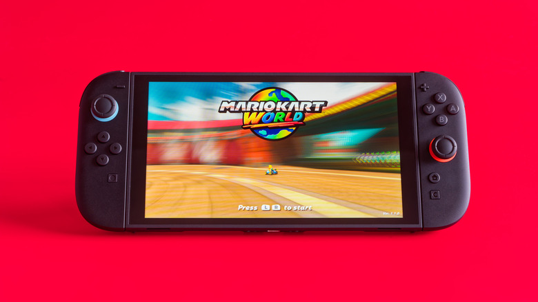 The Nintendo Switch 2 on a red background, running Mario Kart World