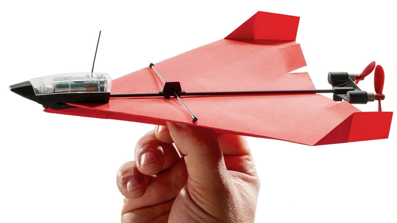Person holding an electronic airplane