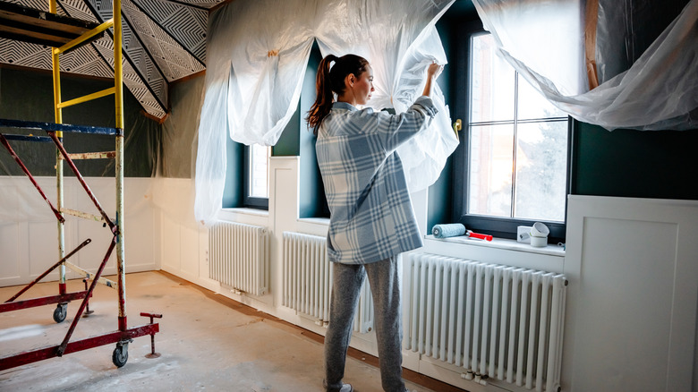 woman inspecting windows during big renovation project