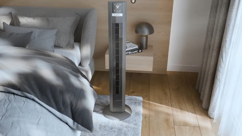 The Lasko oscillating tower fan in a bedroom