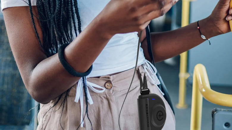 The pocket juice charger attached to a woman's belt loop