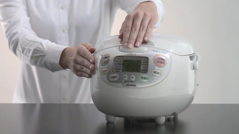 The Zojirushi rice cooker on display, with the top closed.