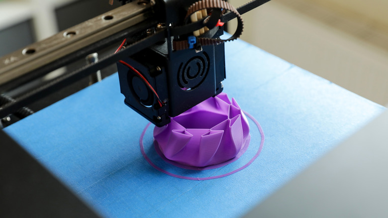 3D printer creating a purple geometric object
