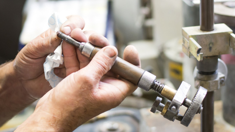 Man polishing a gemstone with a tool