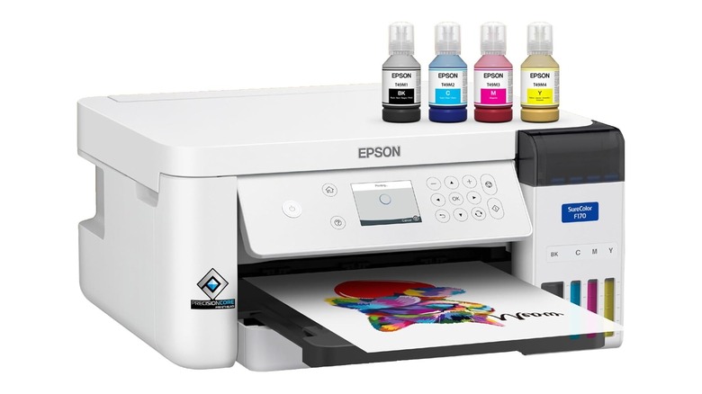 White Epson brand printer with colored bottles of ink resting on top