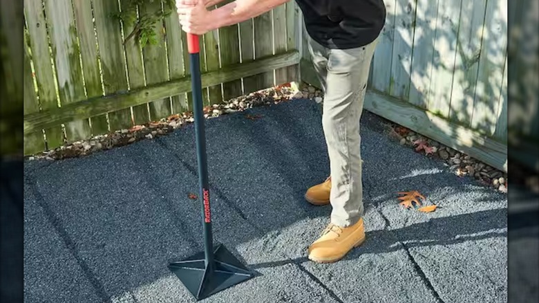 A worker tamping gravel with Razor-Back tamper