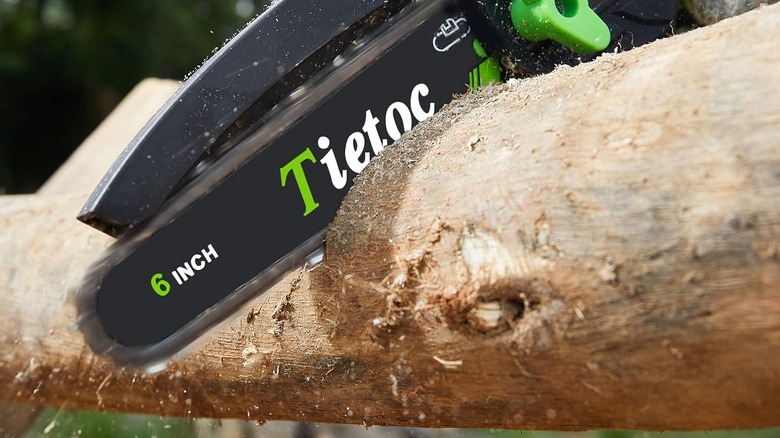 A tree being cut by a saw.