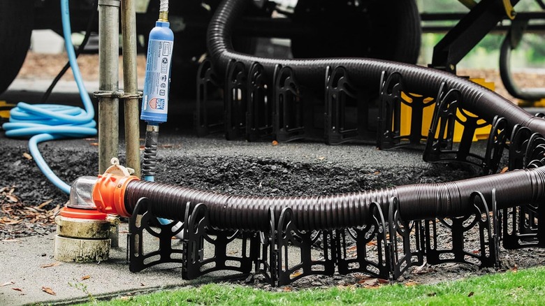 A sewer line being run from a house into a sewer.