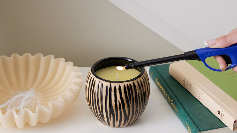 Lighting a candle with extended lighter