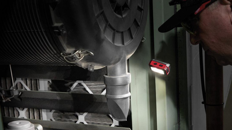The Milwaukee Magnetic Headlamp and Task Light attached to a metal surface.