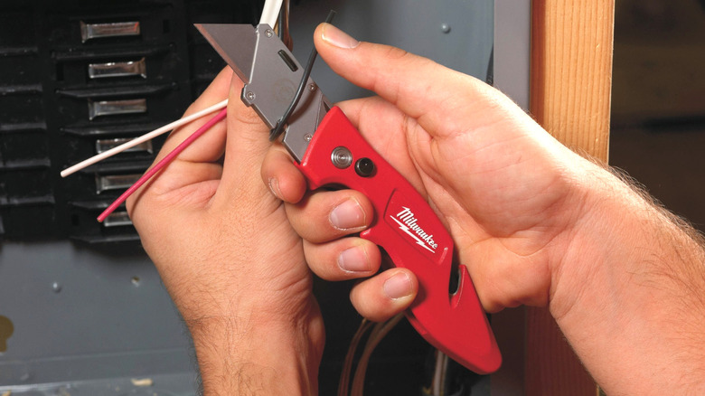 Milwaukee folding knife used to cut wire.