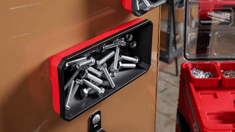 Magnetic bin holders mounted on a ferrous wall.
