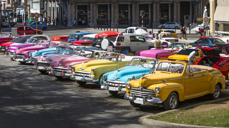 row of classic cars in parking lot