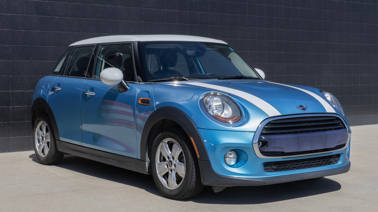 Blue mini cooper parked in front of building