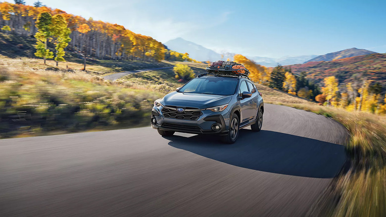 A blue 2025 Subaru Crosstrek driving