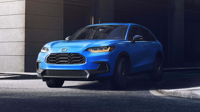A blue 2026 Honda HR-V driving through the streets