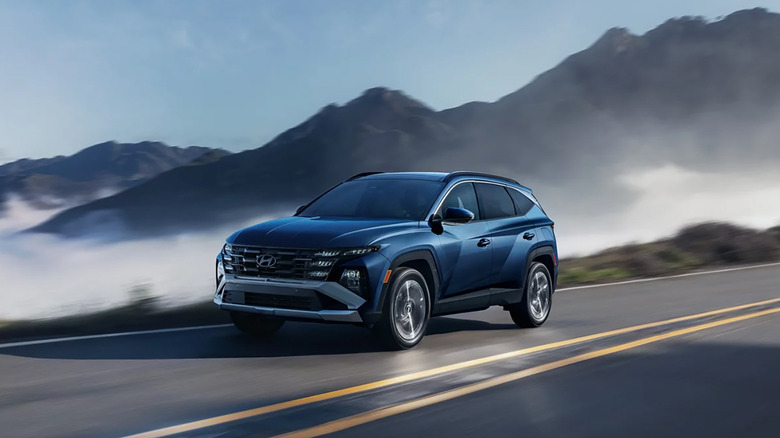 A blue 2026 Hyundai Tucson driving