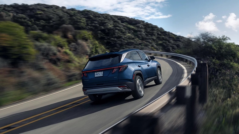 A blue 2026 Hyundai Tucson driving