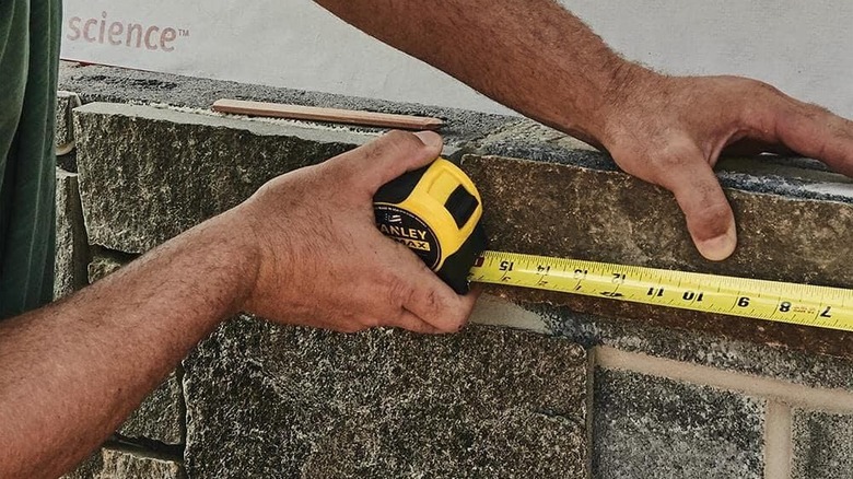 man using Stanley tape measure