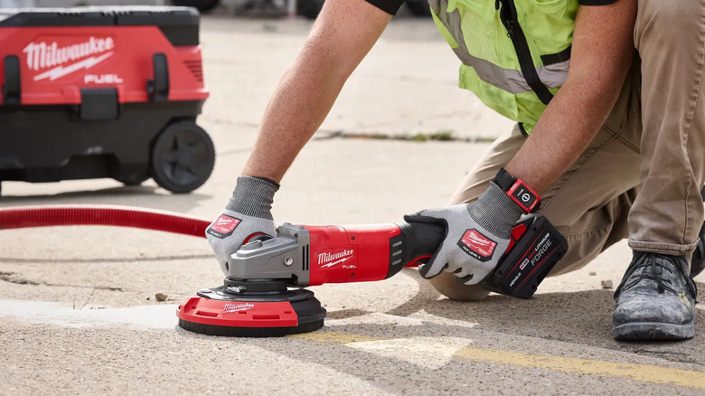 A surface grinding dust shroud being used on the ground.