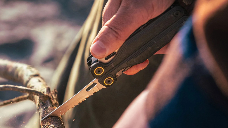 Leatherman Wave Alpha using the knife on a branch