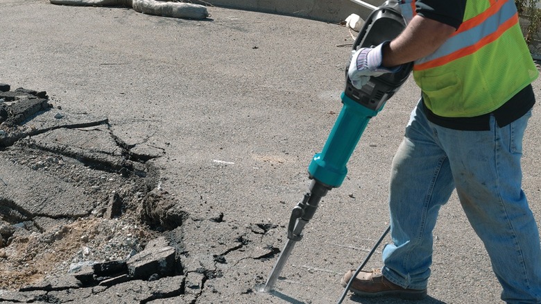 Person using Makita breaker hammer
