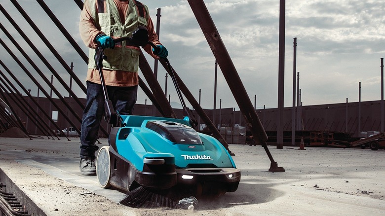 Person using Makita vacuum sweeper