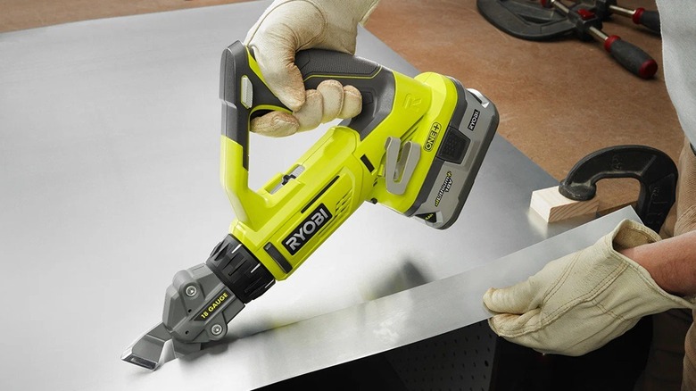 Person cutting sheet metal with Ryobi offset shears.