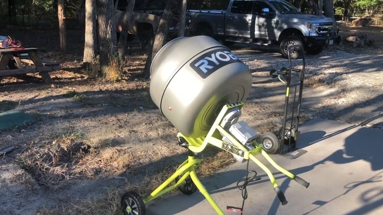 Ryobi cement mixer in a yard.